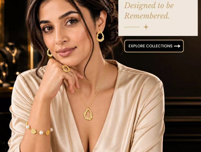 Luxury gold-plated jewellery worn by a woman in an elegant cream outfit, showcasing Mitrava jewellery in a sophisticated boutique setting.