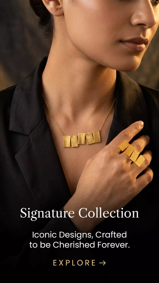 Woman wearing a gold statement necklace and matching ring from Mitrava’s signature jewellery collection.