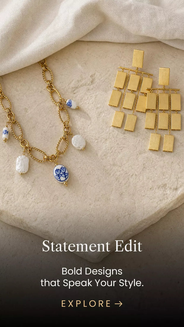 Gold statement earrings and a pearl-detailed necklace displayed in Mitrava’s bold jewellery collection.